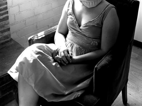 Woman in chair with head covered