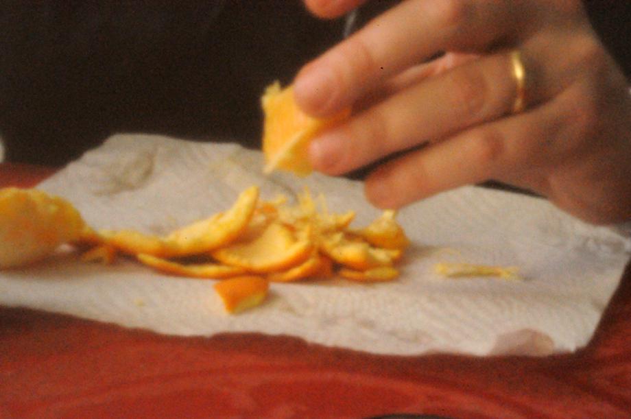 Hands peeling orange