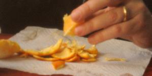 Hands peeling orange