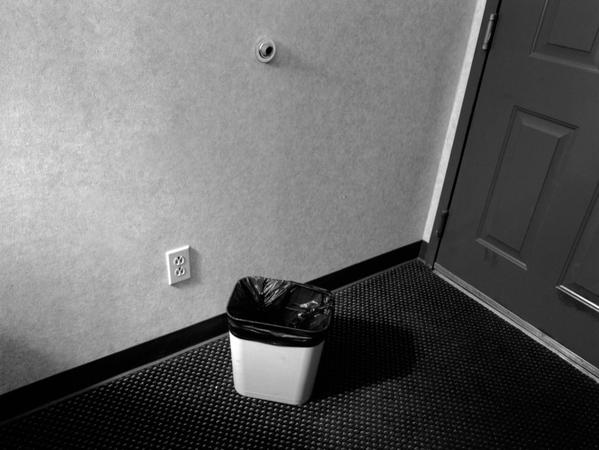 Trash bin by door