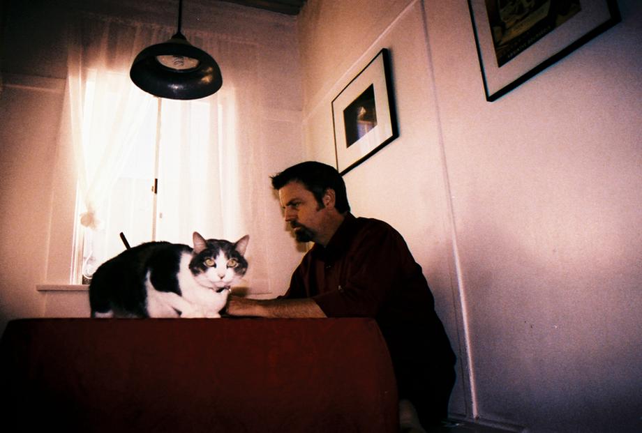 Man and cat at table