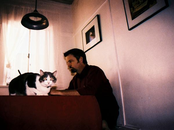 Man and cat at table